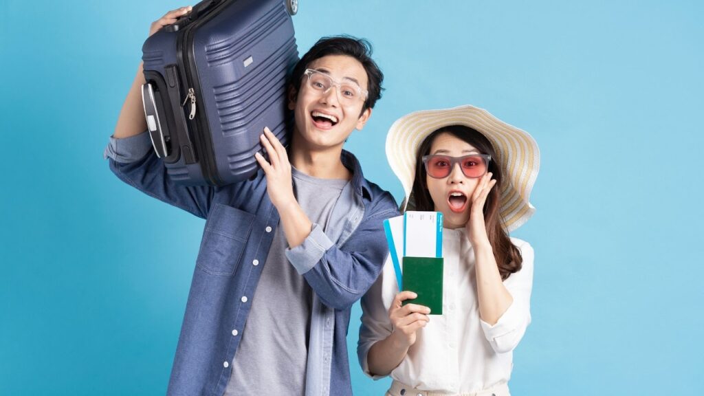 Man and woman with bags and tickets